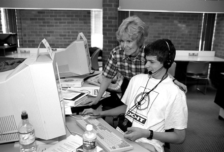 Director Sheryl Burgstahler and Phase I Scholar Carson in COLLAB. Picture of Sheryl and Carson in computer lab.