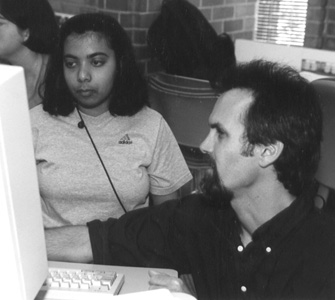 Doug helps Rima with her computer.