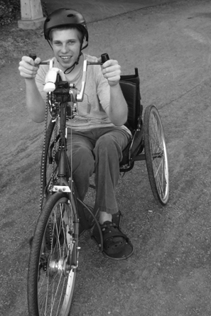 Phase I Scholar Jeremy bikes during the Tour de UW. Picture of Jeremy on a modified bike.