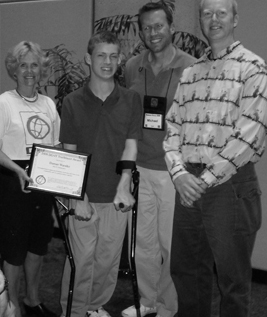 Picture of Sheryl, Michael, Terry, and Daman posing in front of the Trailblazer Award.