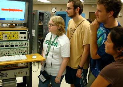 Picture of Brianna, Aaron, and Collin looking at lab equipment.