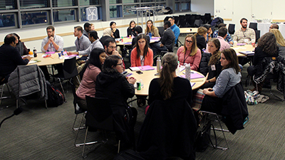 Tables of participants working together.