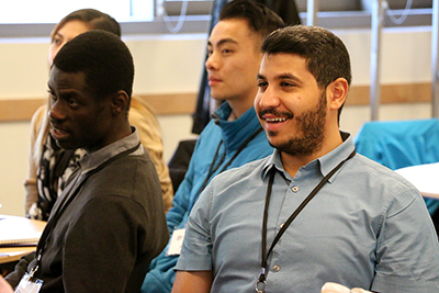 Two participants watch a presentation.