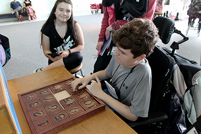 Two students complete a puzzle at the Pacific Science Center.