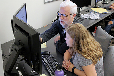 AccessComputing PI Richard Ladner assists a K-12 student with a computing projects during a Quorum coding camp at UW.