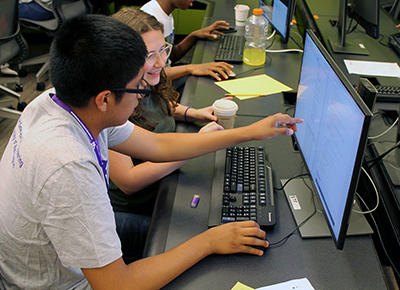 A student and educator work on a quorum project together.