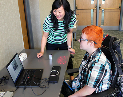 An Assistive Technology Specialist shows off facial tracking software to a University of Washington student.