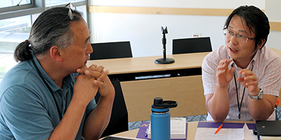 Visiting Scholar Jungsoo discusses accessibility with a participant.
