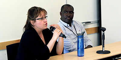 Panelist Ana Thompson answers a question with panelist Claver Hategekimana in the background.