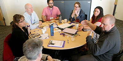 A group of participants discuss accessibility barriers on campus.