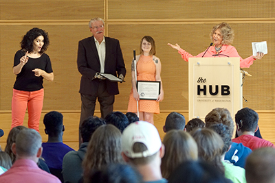 Sheryl presents the Trailblazer Award to John Kemp and Courtney Cole while an interpreter translates.