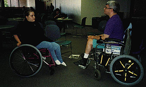 DO-IT Phase II Scholar Jenny and Mentor Douglas Lefever discuss college and the Internet during a free moment at the 1994 Summer Study Picture of Phase II Scholar Jenny and Mentor Douglas