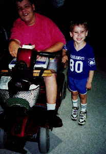 DO-IT Scholar, Anthony, and Travis Burgstahler laugh it up at Camp Courage. Picture of Travis and Anthony