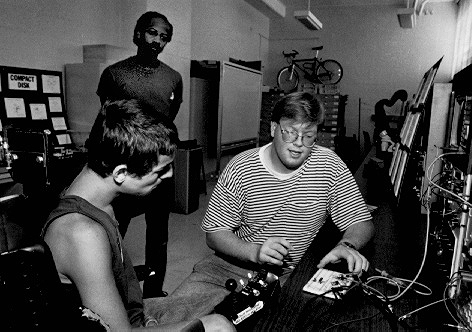 Hollis Listens carefully as the professor explains some details behind the workings of an electronic component. Hollis -- always the mechanical one of the bunch. Picture of Hollis listening to the details behind an electronic component explained by the professor