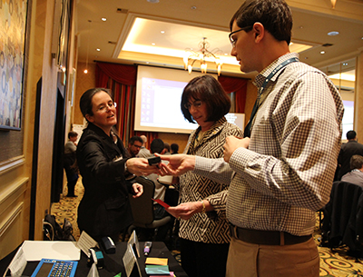 A participant sharing interest in the accessible science equipment with another participant.