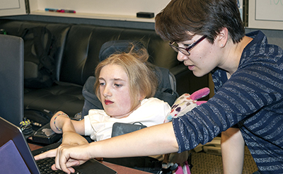 Two students work on a project together in a computing research lab.