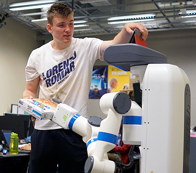 A student works on a robot.