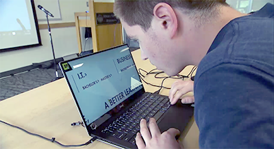 A student uses enlarged text to view his computer.