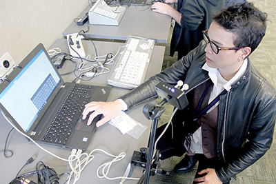 A UW staff members tries out some assistive technology.