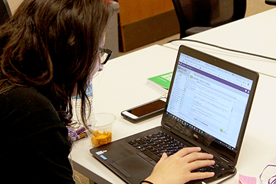 A student uses HTML to edit on a laptop