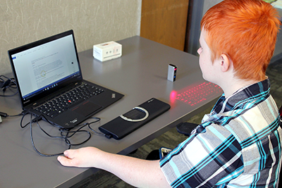 A student uses assistive technology on a laptop