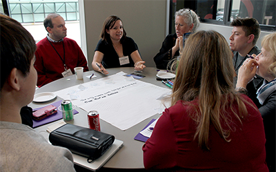 Ed-ICT Seattle Symposium attendees work in small groups.