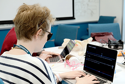 Meredith uses her laptop at the OurCS@UW+AccessComputing conference in April.