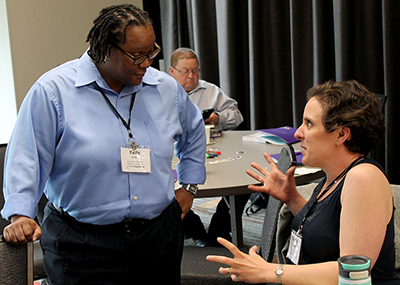 Two participants share ideas at the AccessEngineering capacity building institute.