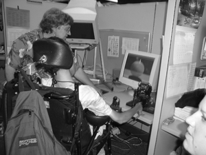 Photo of a mobility impaired student using a computer.