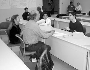 Students during mock interviews. Image of students participating in mock interviews with employees.