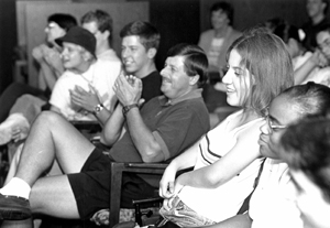 Photo of an audience of students and staff responding positively to a presenter.