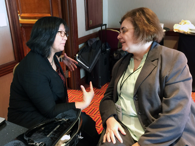 Two women discuss issues together at the AccessCS10K CBI.