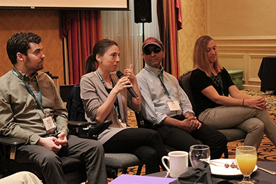 The panel sits while one panelist speaks.