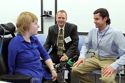 A student in a wheelchair chats with two ERC instructors.