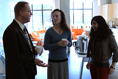 Scott Bellman chats with two participants over coffee.