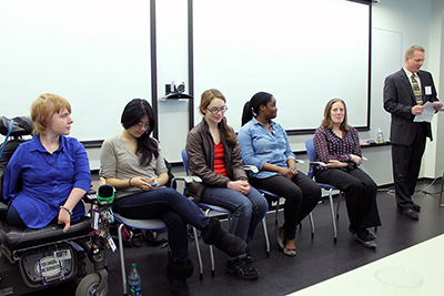 A row of students with disabilities answer questions as a panel.