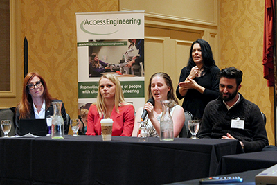 Cindy Bennett speaks on a panel while an interpreter signs behind her. Cindy Bennett speaks on a panel while an interpreter signs behind her.