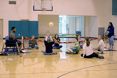 -	Scholars, Interns and staff play a game of seated volleyball at the accessible sports expo during Summer Study 2016.