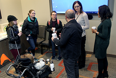 Panelists speak with participants.