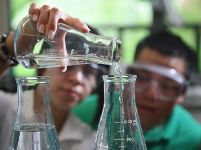 Image of students conducting an experiment in a chemistry lab