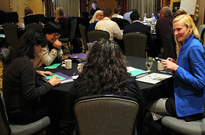 Participants share a laugh around the table.