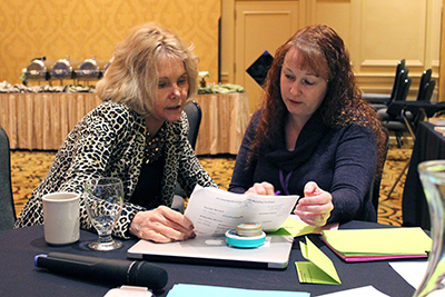 PI Sheryl Burgstahler discusses upcoming events when program coordinator Lyla Crawford.