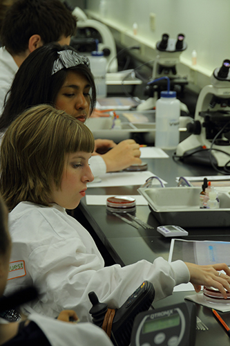 Two students complete a science experiment.