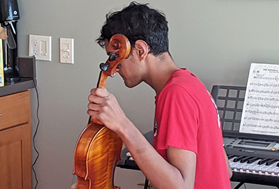 A student plays violin. A student plays violin.