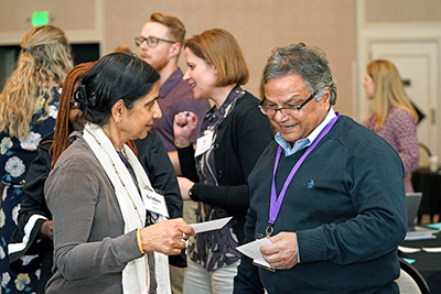 Two participants chat over an ice breaker.