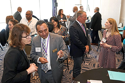 Participants chat around the room.