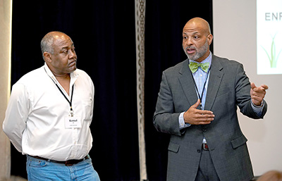 Two presenters share at the front of the room.