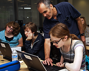 Image of an instructor assisting a student on the computer