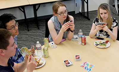 Scholars play Uno at a networking event. Scholars play Uno at a networking event.