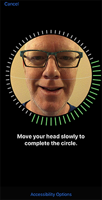 Terrill Thompson setting up Face ID, with on-screen instructions 'Move your head slowly to complete the circle' and a link to 'Accessibility Options'.